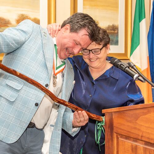 Wood carver Denise LeMay, right, presents a shillelagh, an Irish ceremonial walking stick, to Martin Hogan, the grand marshal of the Savannah St. Patrick’s Day Parade, at a ceremony in Savannah, Georgia on Tuesday, March 3, 2026. The annual parade is March 17 and LeMay has carved shillelaghs for its grand marshals for 22 years. (Kaitlin Sells)