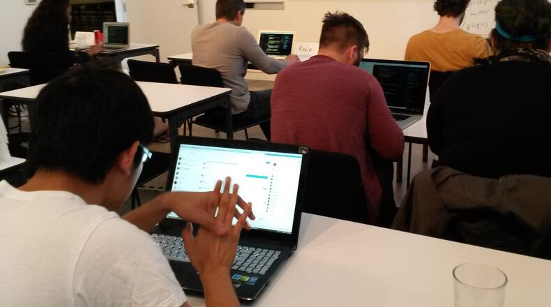 Metro Atlanta is awash in for-profit coding classes. Here, students hunch over laptops at General Assembly, which opened a classroom at Ponce City Market in Atlanta last year.