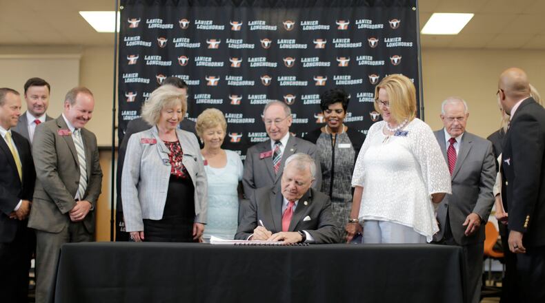 Gov. Nathan Deal signs this year’s budget at Lanier High School in Buford. BOB ANDRES / BANDRES@AJC.COM