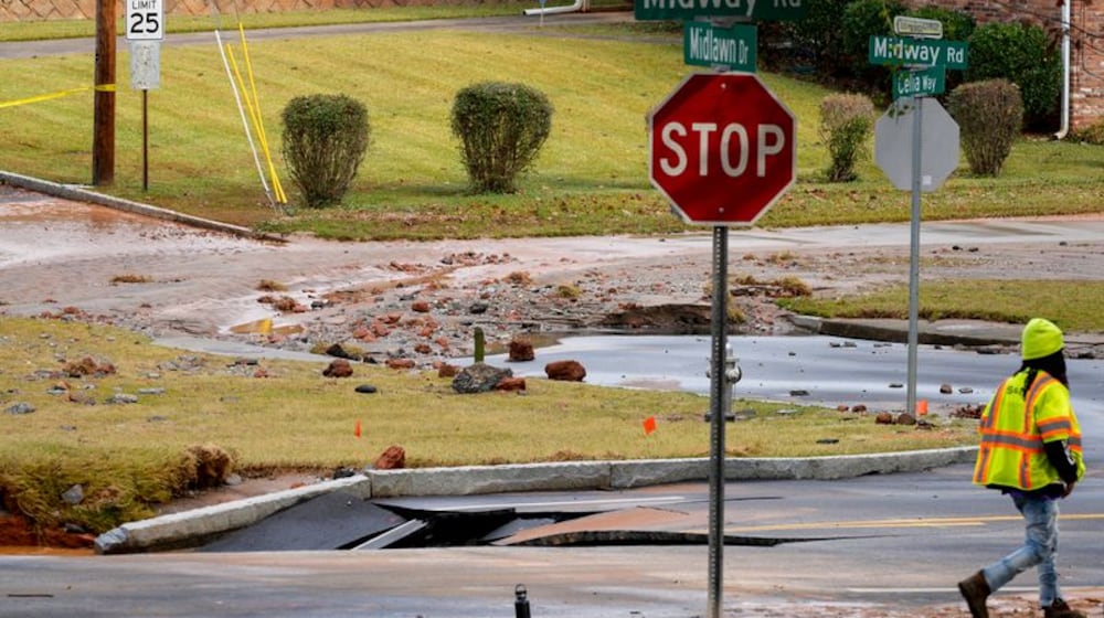 A DeKalb County water main break closed a portion of Midway Road on Monday. The Decatur school district canceled classes. (Ben Hendren for the AJC)