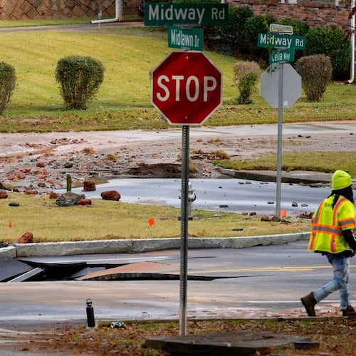 A DeKalb County water main break closed a portion of Midway Road on Monday. The Decatur school district canceled classes. (Ben Hendren for the AJC)