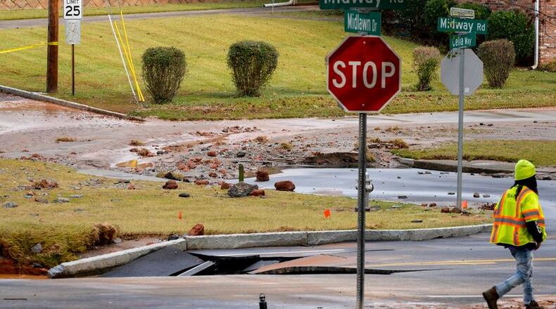 A DeKalb County water main break closed a portion of Midway Road on Monday. The Decatur school district canceled classes. (Ben Hendren for the AJC)