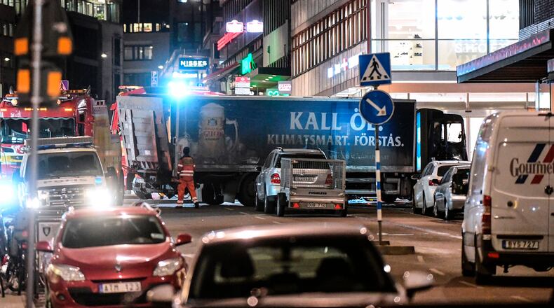 A truck (bottom, blue) crashed into the Ahlens department store at Drottninggatan in central Stockholm, police said.