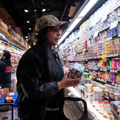Kashish Ali shops for groceries before filling a One Love Community Fridge, Nov. 15, 2025, in Brooklyn, New York. (AP Photo/Adam Gray)