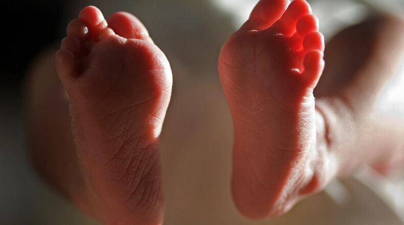 KNUTSFORD, UNITED KINGDOM - APRIL 03: (FILE) In this file photograph taken on March 20, 2007, a two-week-old boy finds his feet in his new world. Health Secretary Patricia Hewitt announced, April 3, 2007 that for the first time, mothers-to-be will have a guarantee that the NHS will provide them with a full range of birthing choices - including home births - and a midwife they know and trust to care for them. (Photo by Christopher Furlong/Getty Images)