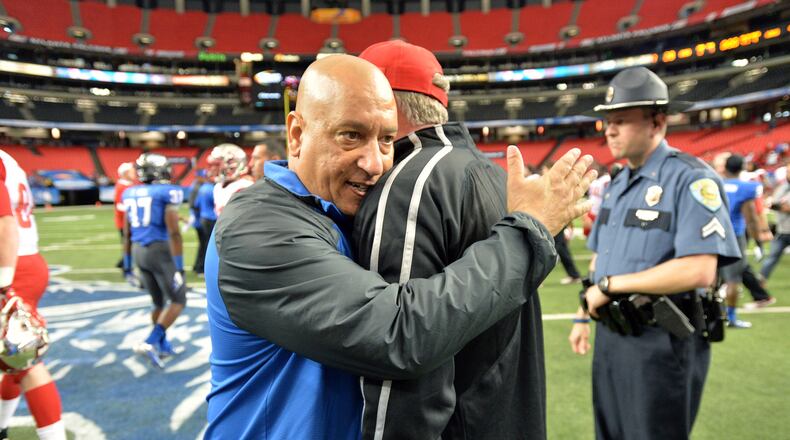 Georgia State Panthers head coach Trent Miles (left) hugs Western Kentucky Hilltoppers head coach Bobby Petrino following the game at the Georgia Dome on Saturday, November 2, 2013. The Hilltoppers won 44-28.