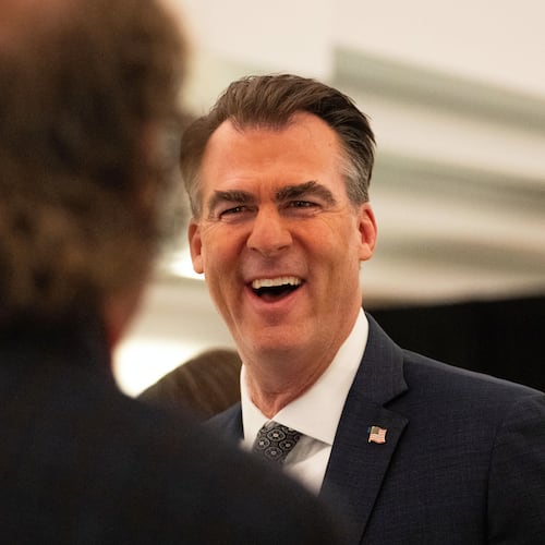 FILE - Oklahoma Gov. Kevin Stitt speaks with an individual following an event at the National Governors Association Winter Meeting, Feb. 19, 2026, in Washington. (AP Photo/Allison Robbert, File)