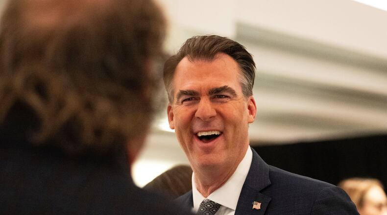 FILE - Oklahoma Gov. Kevin Stitt speaks with an individual following an event at the National Governors Association Winter Meeting, Feb. 19, 2026, in Washington. (AP Photo/Allison Robbert, File)