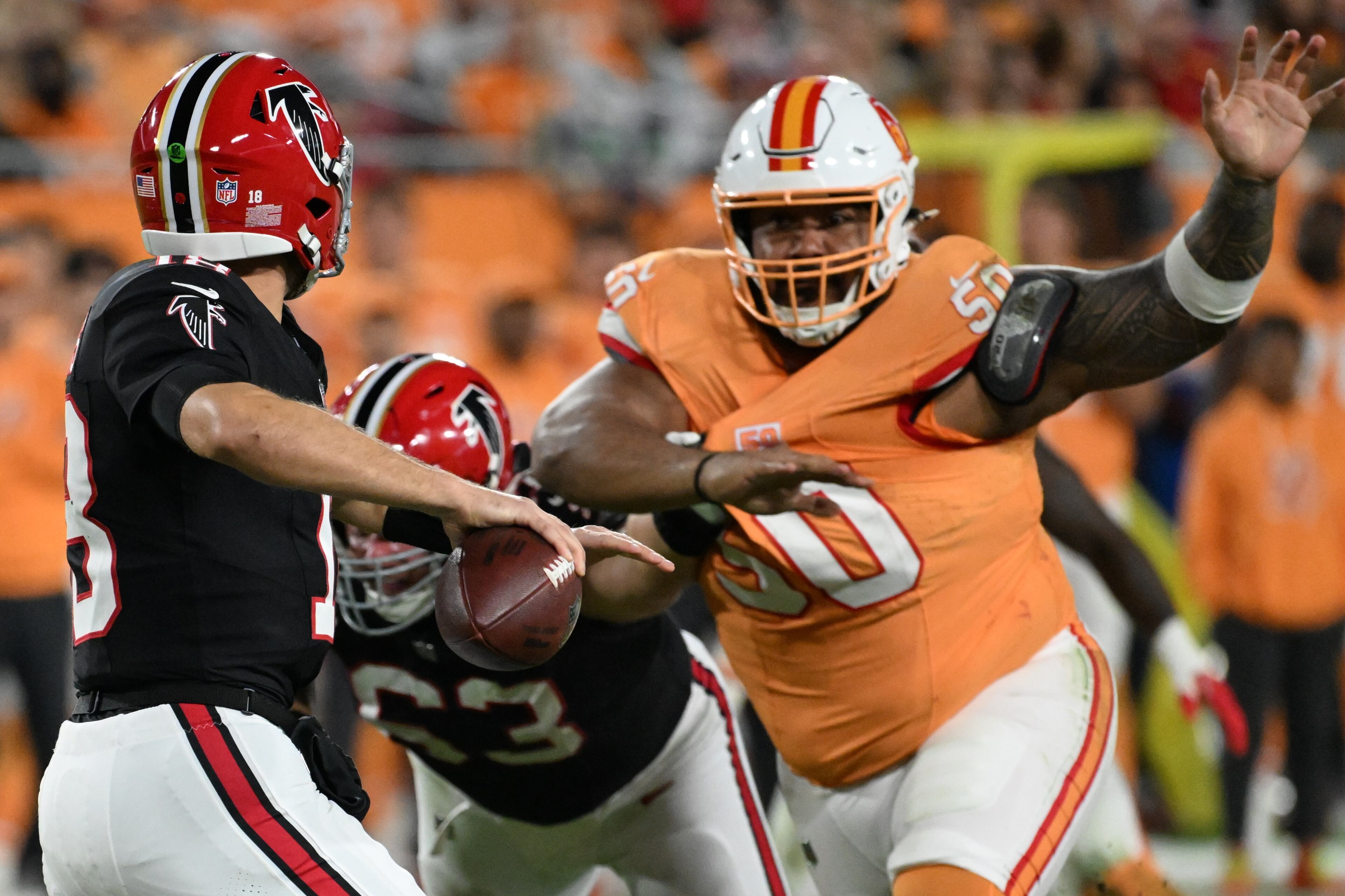 Atlanta Falcons quarterback Kirk Cousins (18) passes against Tampa Bay Buccaneers defensive tackle Vita Vea (50) during the first half of an NFL football game, Thursday, Dec. 11, 2025, in Tampa, Fla. (AP Photo/Jason Behnken)