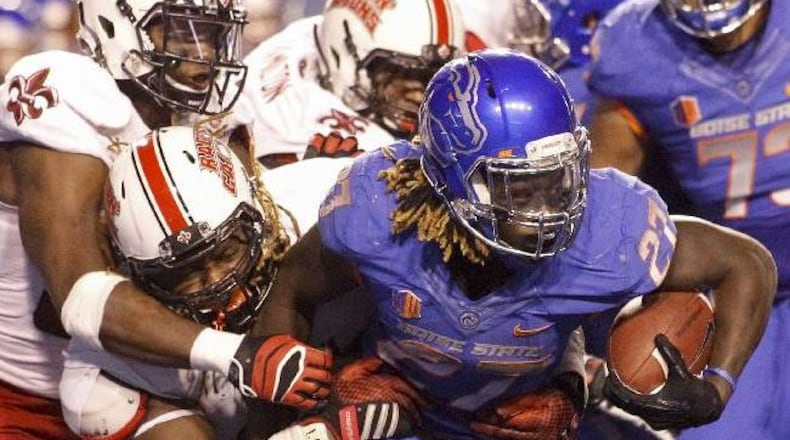 Boise State running back Jay Ajayi (27) runs the ball against Louisiana-Lafayette defensive tackle Jacoby Briscoe (behind Ajayi) and linebacker Boris Anyama during the second half of an NCAA college football game in Boise, Idaho, on Saturday, Sept. 20, 2014. Boise State won 34-9. (AP Photo/Otto Kitsinger)