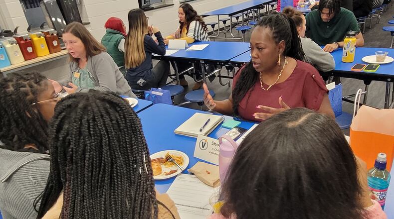 Students at Victory College Prep high school in Indianapolis meet with Shontay Martin, founder of a home childcare company, about internships they are about to start with the company. The school is a leader in Indiana for giving students workplace experiences, which are about to become far more common as the state overhauls its high schools to better prepare students for careers. (Patrick O’Donnell)