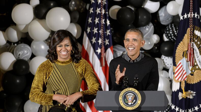 WASHINGTON, DC - OCTOBER 31: Barack Obama and Michelle Obama speak during a Halloween event in the East Room of the White House October 31, 2016 in Washington, DC. The former first couple hosted local children and children of military families for trick-or-treating at the White House. (Photo by Olivier Douliery-Pool/Getty Images)