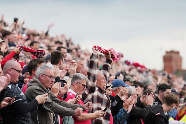 Wrexham fans watch the English League One soccer match between Wrexham and Charlton Athletic at the Racecourse ground in Wrexham, Wales, Saturday, April 26, 2025. (AP Photo/Jon Super)