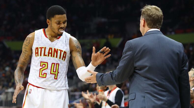 Hawks’ Kent Bazemore gives head coach Mike Budenholzer five during the final minute of a 102-98 victory over the Knicks in a NBA basketball game on Wednesday, Dec. 28, 2016, in Atlanta. Curtis Compton/ccompton@ajc.com