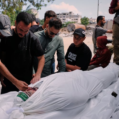 Palestinians mourn over the body of Mohammad Odeh, whom Israel says was a leader of Hamas Qassam Brigades, a day after he was killed in an Israeli airstrike, during his funeral in Gaza City, Wednesday, May 27, 2026. (AP Photo/Jehad Alshrafi)