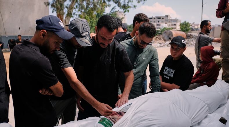 Palestinians mourn over the body of Mohammad Odeh, whom Israel says was a leader of Hamas Qassam Brigades, a day after he was killed in an Israeli airstrike, during his funeral in Gaza City, Wednesday, May 27, 2026. (AP Photo/Jehad Alshrafi)