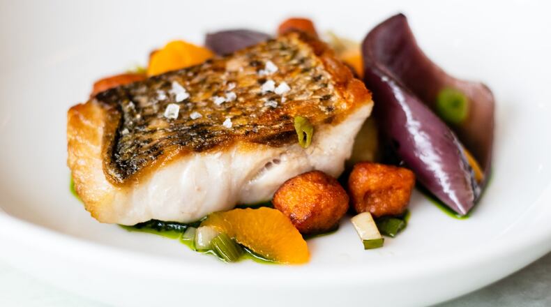 Redfish with nicely crisped skin is served at Adalina with colorful red-wine-braised onions, satsuma segments, sweet-potato gnocchi, pistou and ceci peas. CONTRIBUTED BY HENRI HOLLIS