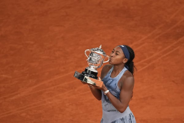 Winner Coco Gauff of the U.S. kisses the trophy after the final match of the French Tennis Open against Aryna Sabalenka of Belarus at the Roland Garros stadium in Paris, Saturday, June 7, 2025. (Christophe Ena/AP)