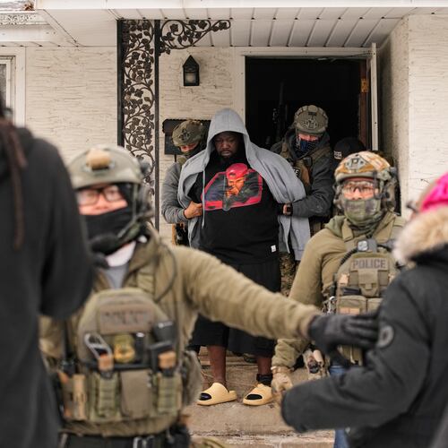 ADDS IDENTIFICATION: Garrison Gibson is arrested by federal immigration officers Sunday, Jan. 11, 2026, in Minneapolis. (AP Photo/John Locher)