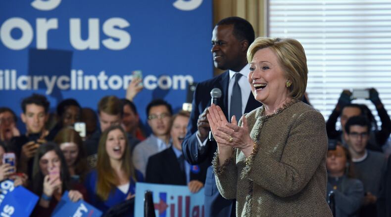 Democratic presidential candidate Hillary Clinton speaks as Atlanta Mayor Kasim Reed (right) supports her at a February event in Coca-Cola’s hometown. HYOSUB SHIN / HSHIN@AJC.COM