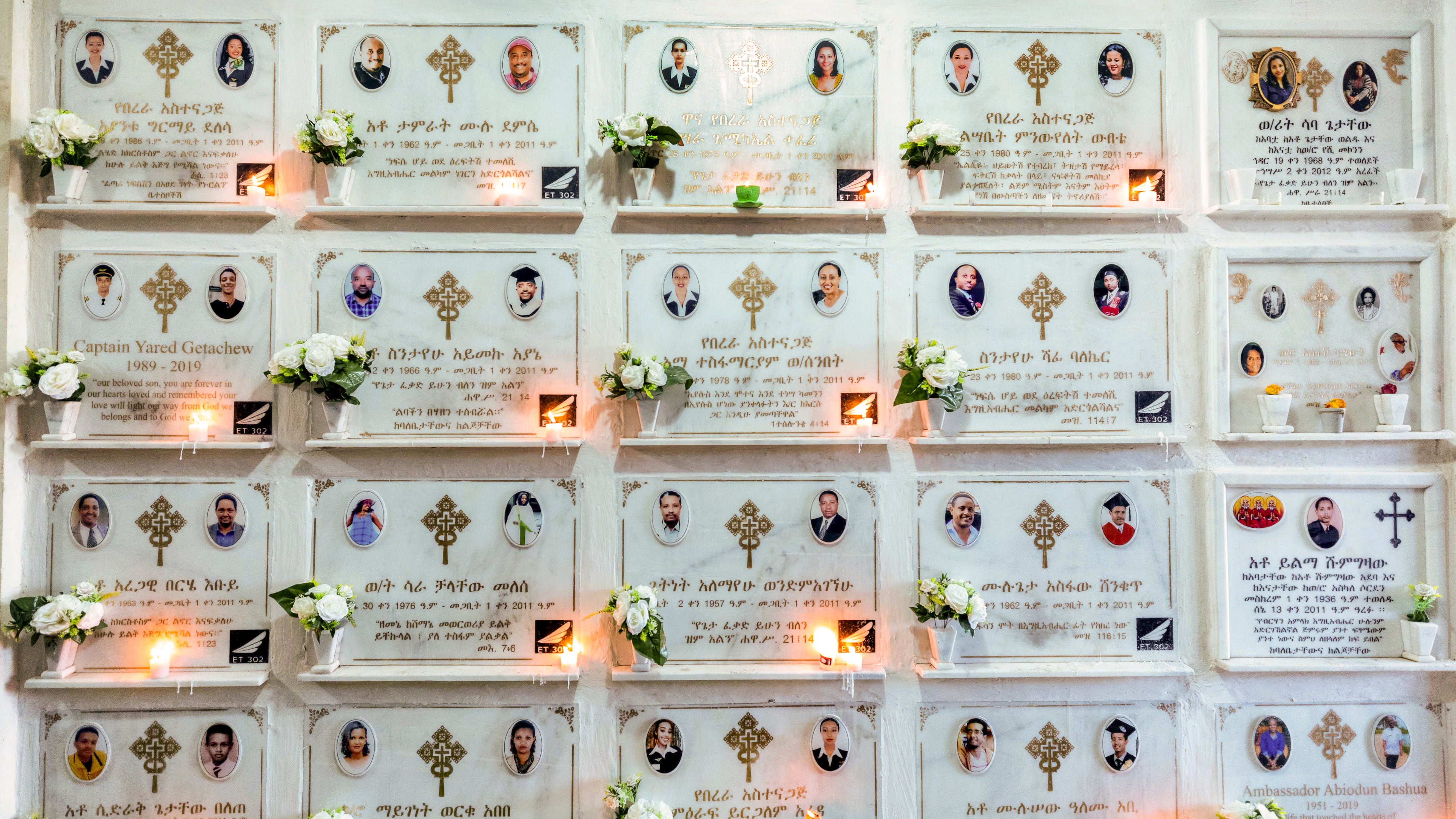 FILE - Candles are lit on a memorial wall during an anniversary service at the Holy Trinity Cathedral in Addis Ababa, Ethiopia, March 8, 2020, to remember those who died in the Ethiopian Airlines flight ET302 crash. (AP Photo/Mulugeta Ayene, File)