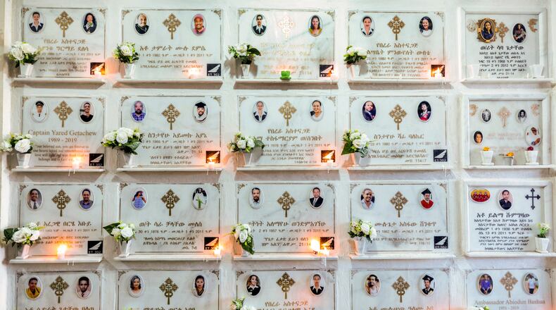 FILE - Candles are lit on a memorial wall during an anniversary service at the Holy Trinity Cathedral in Addis Ababa, Ethiopia, March 8, 2020, to remember those who died in the Ethiopian Airlines flight ET302 crash. (AP Photo/Mulugeta Ayene, File)