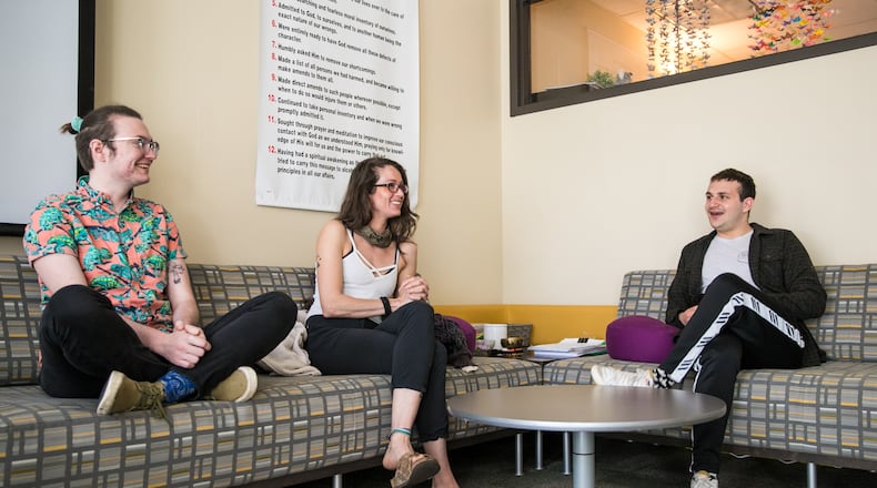 Kennesaw State University has many success stories from their Center for Young Adult Addiction and Recovery programs. A few students, including Frankie Berryman, from left, Kevyn Wakefield and Justin Schechter check in with each other and the center's director on March 3, 2022. The group is going on a sober Spring Break trip together as they connect and support each other in their Twelve Steps. (Jenni Girtman for The Atlanta Journal-Constitution)