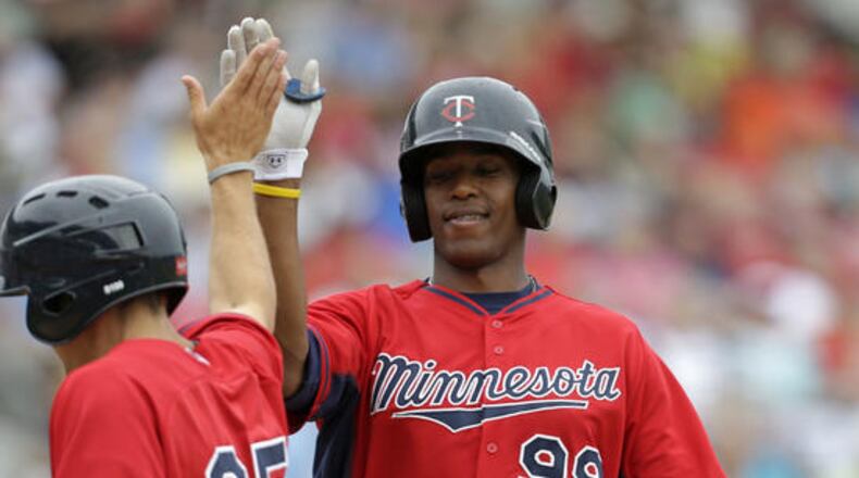 Adam Walker is greeted after a two-run homer in a 2014 spring training game against the Red Sox. The Braves claimed the power-hitting minor league minor league outfielder off waivers last week and outrighted him to the minors on Tuesday after he cleared waivers. (AP file photo)