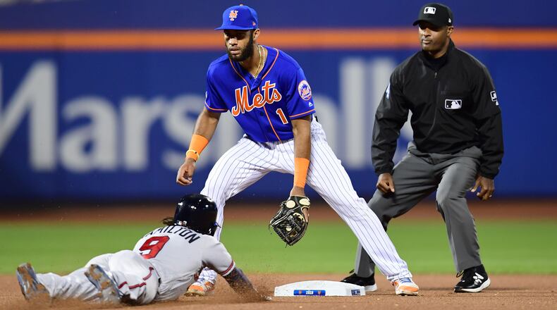 Billy Hamilton slides into second with a stolen base as Amed Rosario of the Mets looks on during Friday's game in New York City. (Photo by Emilee Chinn/Getty Images)