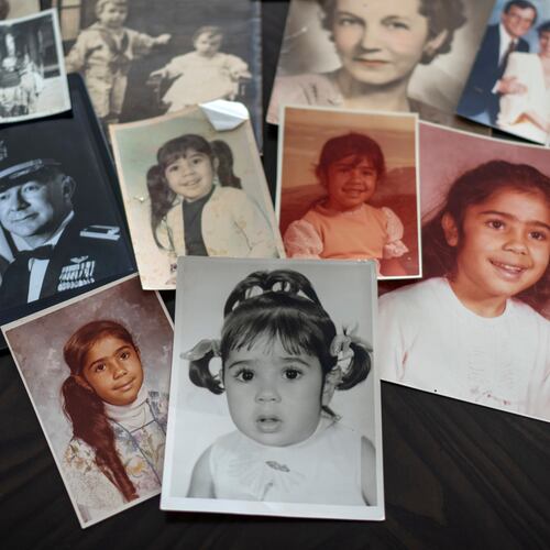 FILE - Childhood photos of a woman adopted as a toddler by an American war veteran, who he found in the 1970s in an Iranian orphanage and raised as a Christian, are displayed along with a picture of her father, a WWII Air Force veteran, at left, and additional family photos, Monday, June 24, 2024, in Henderson, Nev. (AP Photo/David Goldman, File)