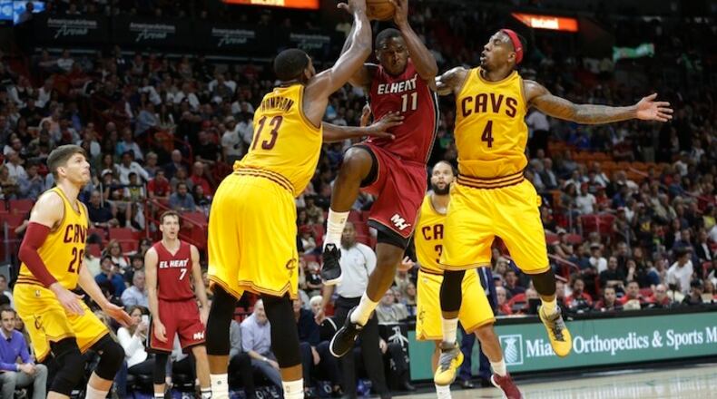 Miami Heat guard Dion Waiters (11) drives to the basket as Cleveland Cavaliers center Tristan Thompson (13) and guard Iman Shumpert (4) defend during the second half of an NBA basketball game, Saturday, March 4, 2017, in Miami. The Heat defeated the Cavaliers 120-92. (AP Photo/Lynne Sladky)