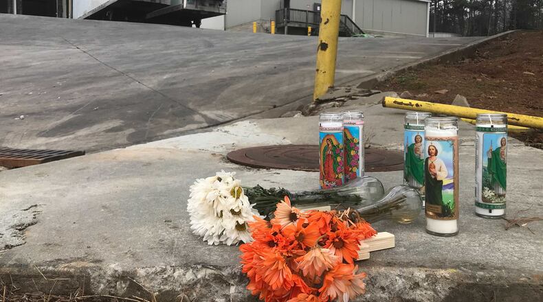 Flowers and candles are seen outside the Foundation Food Group poultry processing plant in Gainesville, Georgia, on Saturday, Jan. 30, 2021. (Photo: Vanessa McCray / Vanessa.McCray@ajc.com)
