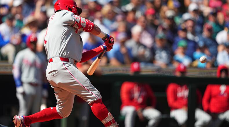 Philadelphia Phillies' Kyle Schwarber hits a three-run home run against Seattle Mariners starting pitcher Bryan Woo during the second inning of a baseball game, Wednesday, Aug. 26, 2026, in Seattle. (AP Photo/Lindsey Wasson)