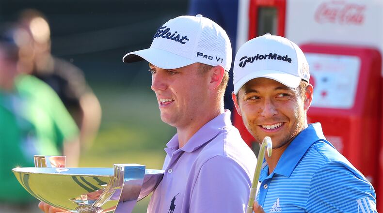 Justin Thomas (left) and Xander Schauffele enjoy the spoils of their various victories at the Tour Championship Sunday. (Curtis Compton/ccompton@ajc.com)
