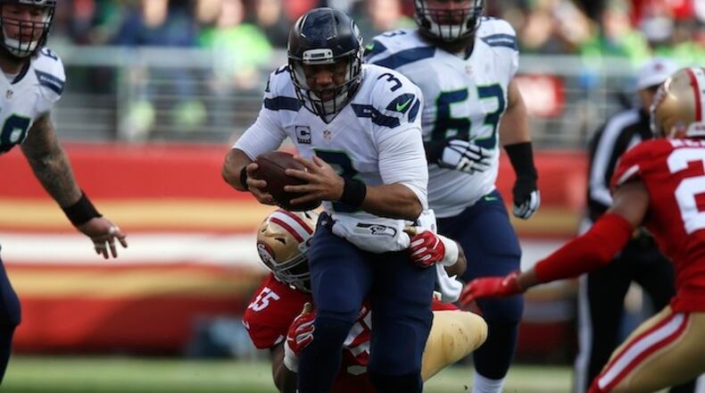 Seattle Seahawks quarterback Russell Wilson (3) is tackled at the end of a scramble by the San Francisco 49ers' Ahmad Brooks (55) at Levi's Stadium in Santa Clara, Calif., on January 1, 2017. The offseason has the 28-year-old quarterback feeling, in his words, "super young right now, and that's a great thing. I feel really, really young. I feel I'm just getting started." (Nhat V. Meyer/Bay Area News Group/TNS)