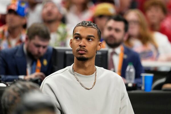 San Antonio Spurs' Victor Wembanyama watches Florida and Houston during the second half in the national championship at the Final Four of the NCAA college basketball tournament, Monday, April 7, 2025, in San Antonio. (AP Photo/Eric Gay)
