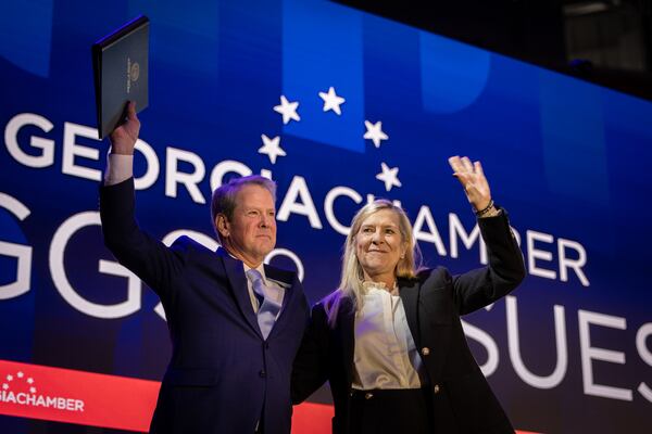 Gov. Brian Kemp and first lady Marty Kemp wave to the audience at an event this past January. (Arvin Temkar/AJC)