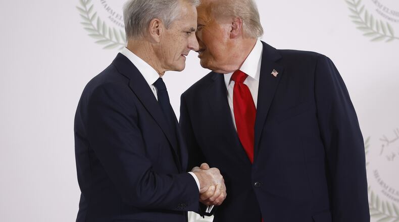 FILE - President Donald Trump and Norway's Prime Minister Jonas Gahr Store shake hands during the group photo at the Gaza International Peace Summit in Sharm el-Sheikh, Egypt, Oct.13 2025. (Yoan Valat, Pool photo via AP, File)