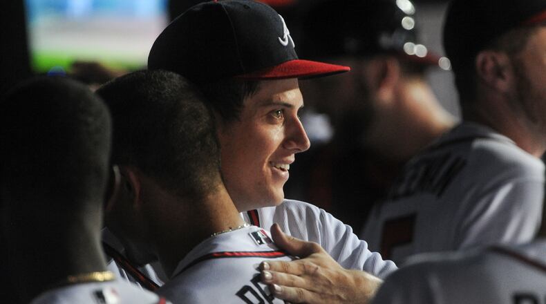 Atlanta Braves starting pitcher Matt Wisler, right, is congratulated in the dugout by Atlanta Braves Jace Peterson after striking out New York Mets' Lucas Duda to turn the side of the eighth inning of a baseball game that was Wislers' MLB debut, Friday, June 19, 2015, in Atlanta. (AP Photo/John Amis )