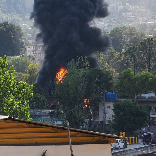 Smoke billows after an army MI-17 helicopter crashed due to a technical fault, in Muzaffarabad, capital of Pakistan-administered Kashmir, Wednesday, June 10, 2026. (AP Photo/M.D. Mughal)
