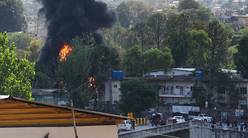 Smoke billows after an army MI-17 helicopter crashed due to a technical fault, in Muzaffarabad, capital of Pakistan-administered Kashmir, Wednesday, June 10, 2026. (AP Photo/M.D. Mughal)