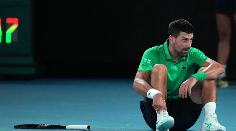 Novak Djokovic of Serbia reacts after a fall during his third round match against Botic van de Zandschulp of the Netherlands at the Australian Open tennis championship in Melbourne, Australia, Saturday, Jan. 24, 2026. (AP Photo/Dita Alangkara)