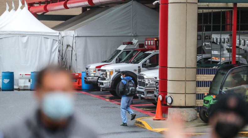 In this file photo, the ambulance bay is full from a surge of COVID-19 patients. (John Spink / John.Spink@ajc.com)