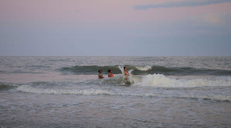 Friends Taking a quick dip in the ocean off Tybee Island to cool off after a day of festivities at Orange Crush on Saturday, April 22.