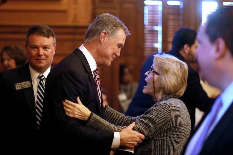 Rep. Susan Holmes (right), R-Monticello, greets U.S. Senator David Perdue in 2019 after he addressed the Georgia General Assembly.  (Bob Andres/AJC)