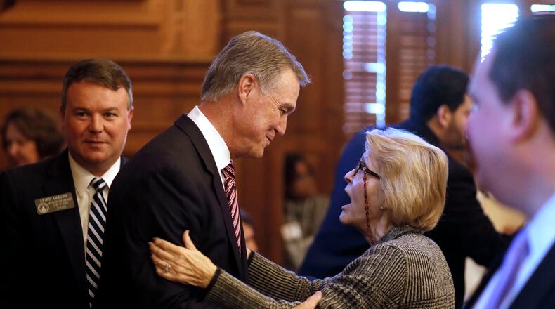 Rep. Susan Holmes (right), R-Monticello, greets U.S. Senator David Perdue in 2019 after he addressed the Georgia General Assembly. (Bob Andres/AJC)