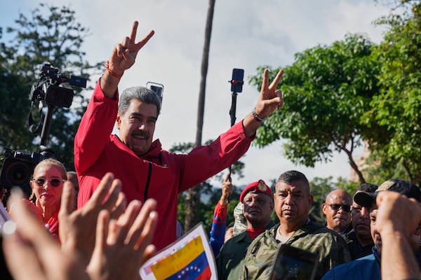 President Nicolas Maduro flashes victory signs during Indigenous Day in Caracas, Venezuela, on Oct 12, 2025. (Ariana Cubillos/AP)