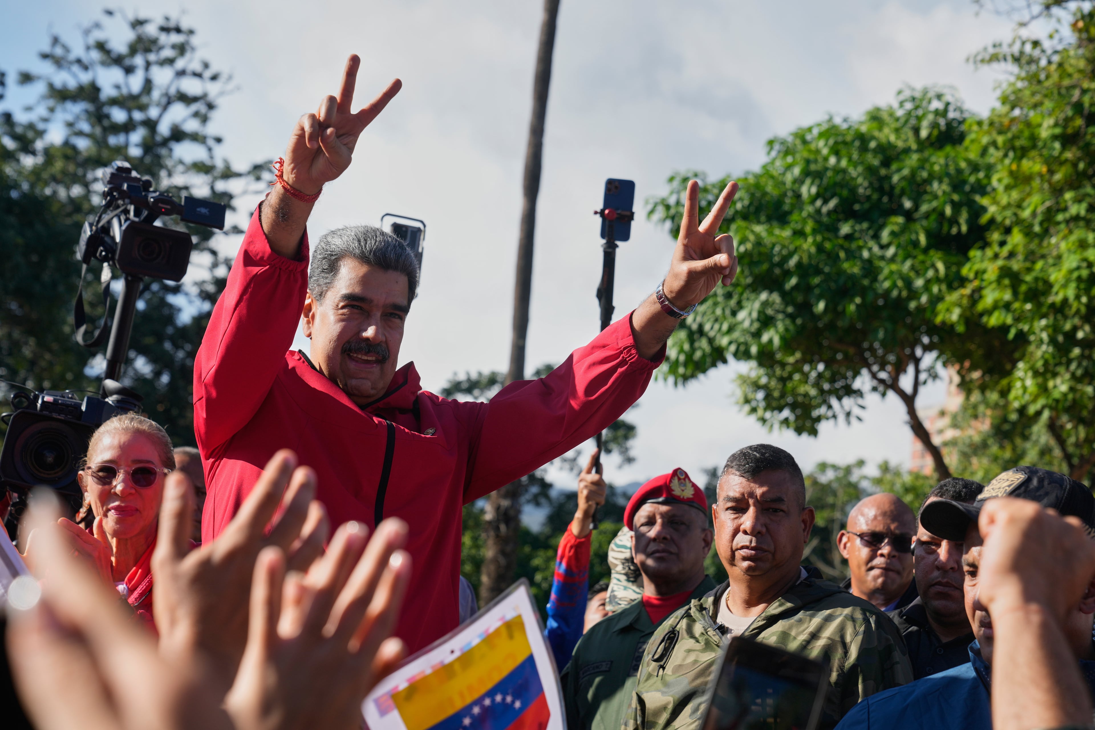President Nicolas Maduro flashes victory signs during Indigenous Day in Caracas, Venezuela, on Oct 12, 2025. (Ariana Cubillos/AP)