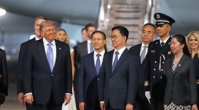 President Donald Trump pauses with China's Vice President Han Zheng during an arrival ceremony Wednesday, May 13, 2026, at Beijing Capital International Airport in Beijing. (AP Photo/Mark Schiefelbein)