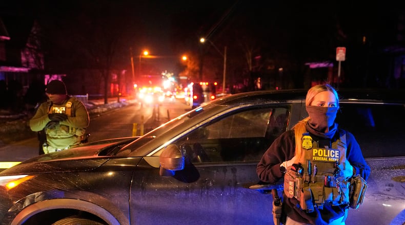 FILE - Federal immigration officers at the scene of a reported shooting Wednesday, Jan. 14, 2026, in Minneapolis. (AP Photo/John Locher, File)